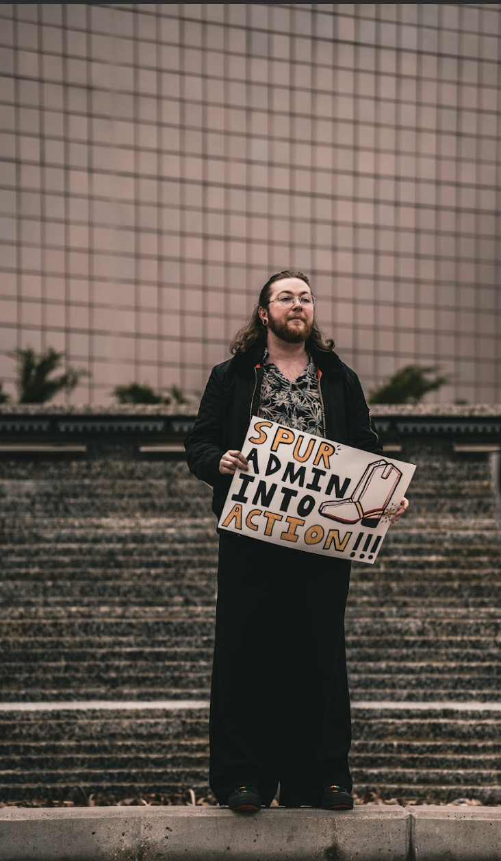 TAU holding sign, Photo Credit: Brandon Goldner