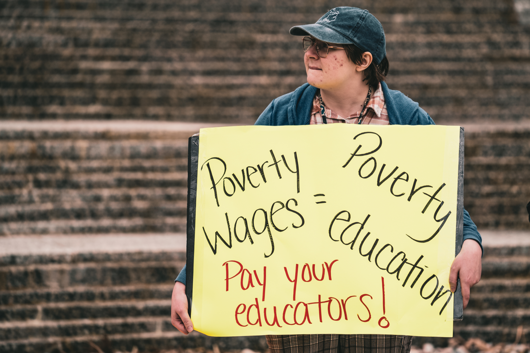 TAU member holding sign, photo credit: Brandon Goldner 